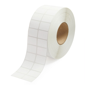 A roll of white adhesive labels with square shapes.