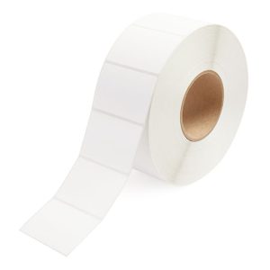 A roll of blank white adhesive labels on a cardboard core.