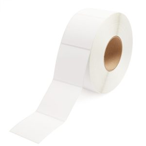 Roll of white adhesive labels on a brown core.