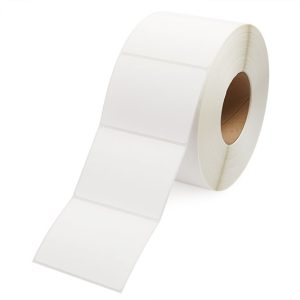 A roll of white adhesive labels on a brown core.