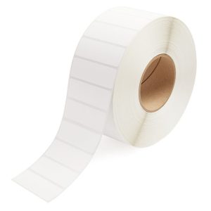 A large roll of white adhesive labels with rectangular shapes.
