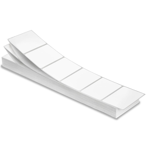 A stack of blank white adhesive labels arranged in a neat pile.